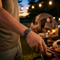 Ultrasonic mosquito repellent bracelet worn during an outdoor evening barbecue